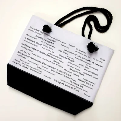 A bag with black handles and white paper.