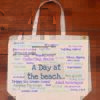 The front half of a canvas tote bag describing fun at the beach!