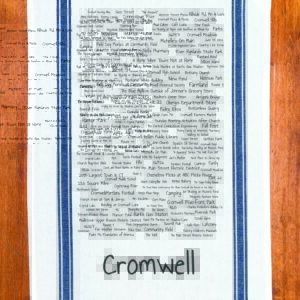 A blue striped towel with trivia about the town of Cromwell, Connecticut
