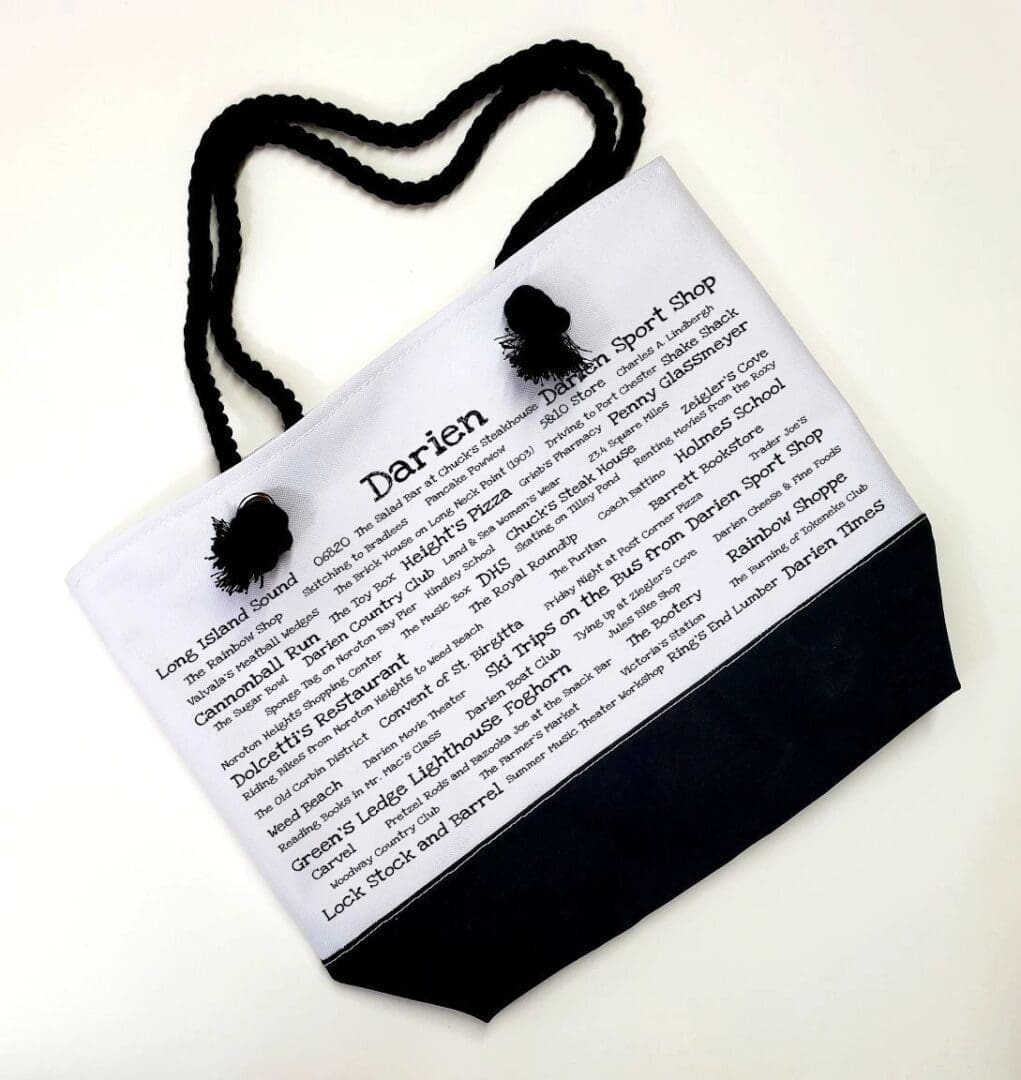 A bag with a black handle and white paper.