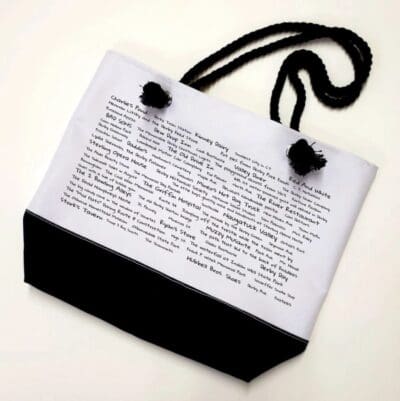 A bag with a black cord and white paper.