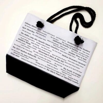 A bag with black handles and white pages.