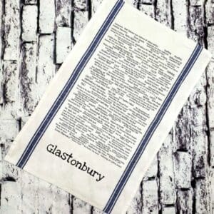 A tea towel with the words glastonbury written on it.