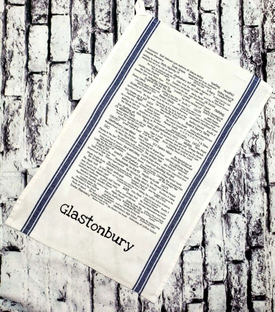 A tea towel with the words glastonbury written on it.