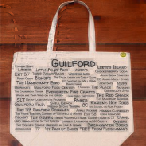 The front half of a canvas tote bag featuring fun trivia about Guilford!