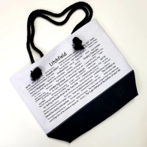 A bag with a black handle and white paper.