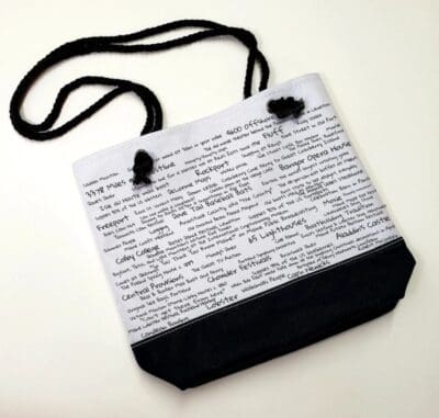 A bag with black cord and white paper.