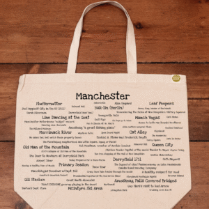 The front half of a canvas tote bag featuring fun trivia about Manchester!