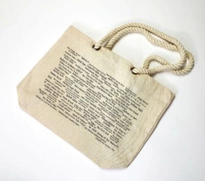 A bag with a rope handle and an old book page.