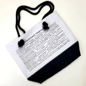 A bag with a black handle and some white paper