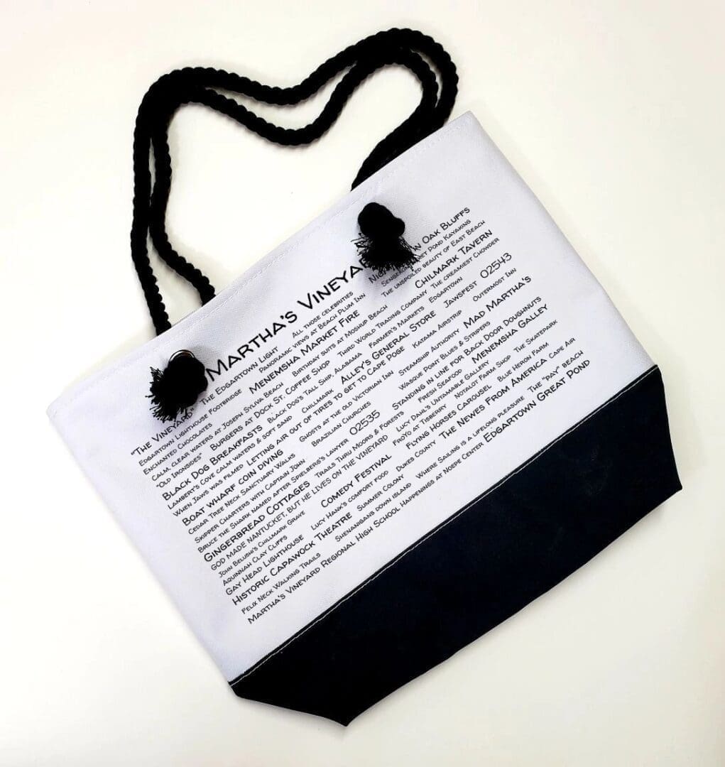 A bag with a black handle and some white paper