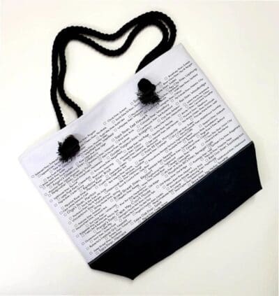 A white and black bag with writing on it