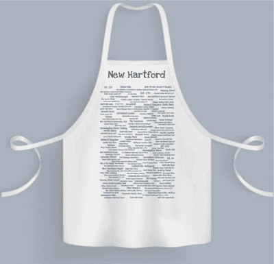 A white apron with many different words on it.