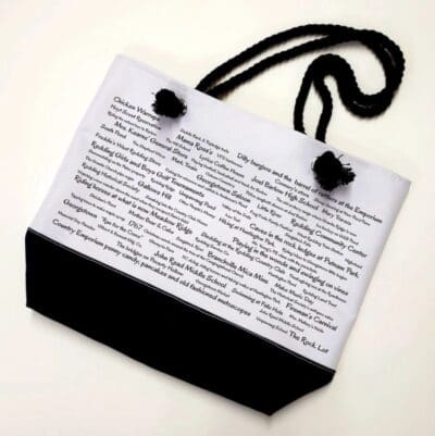 A bag with black cord and white paper.