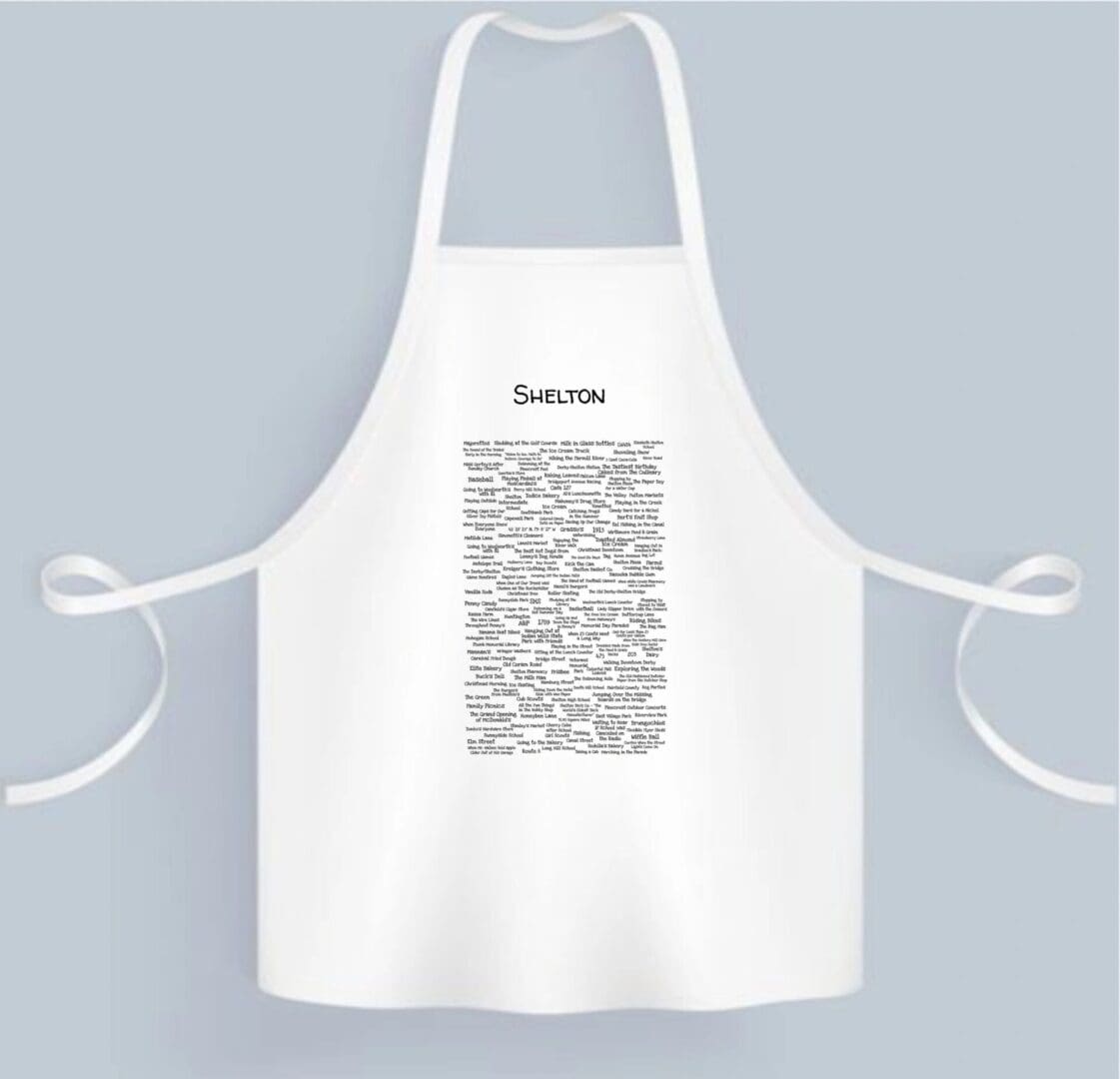 A white apron with a black and white image of the word " karma ".