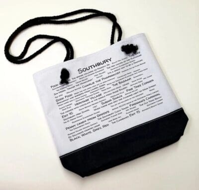 A white bag with black cord and the word " dictionary ".