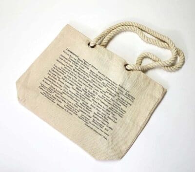 A bag with a string handle and an old book page.