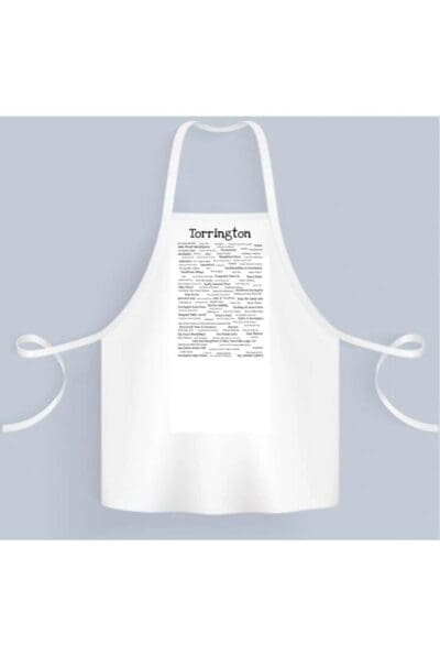 Torrington Pride Chef's Apron with the word "torrington" at the top and a block of text in the center, hanging against a light gray background.