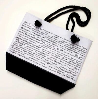 A bag with black cord and white paper.