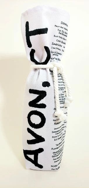 A wine bottle wrapped in newspaper with the word " onion ".