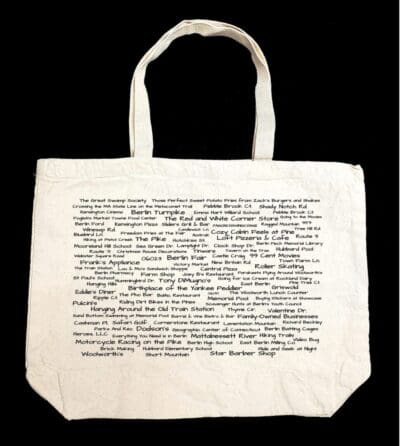 A white bag with the words " i am a woman ".