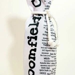 A bottle of wine wrapped in newspaper.