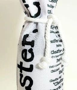 A bottle of wine in a white bag