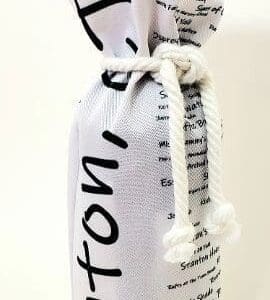 A bottle of wine is wrapped in newspaper.