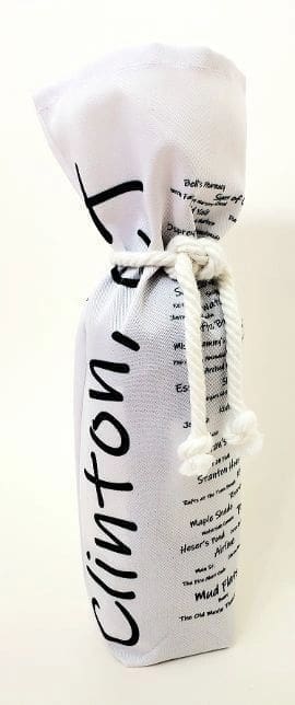 A bottle of wine is wrapped in newspaper.