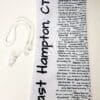 A white neck tie with black writing on it.