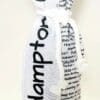 A bottle of wine is wrapped in newspaper.
