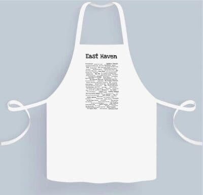 A white apron with a black and white design.