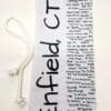 A white tie with black writing on it.