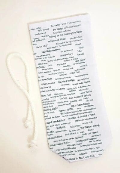 A white bookmark with words written on it.