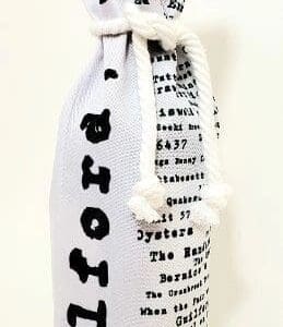 A white bottle bag with black writing on it.