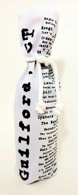 A white bottle bag with black writing on it.