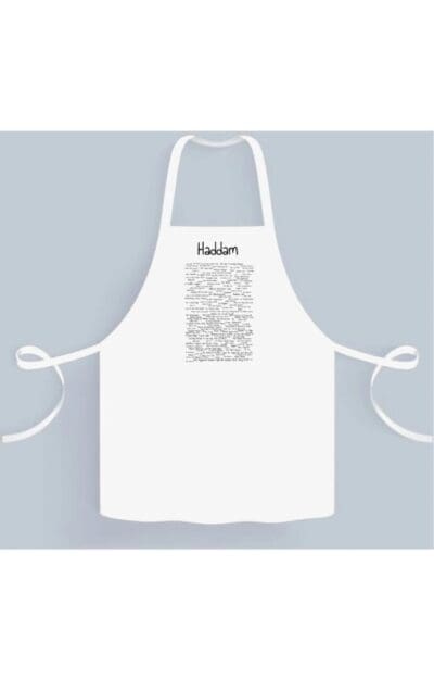 A white apron with the word " kitchen " written on it.