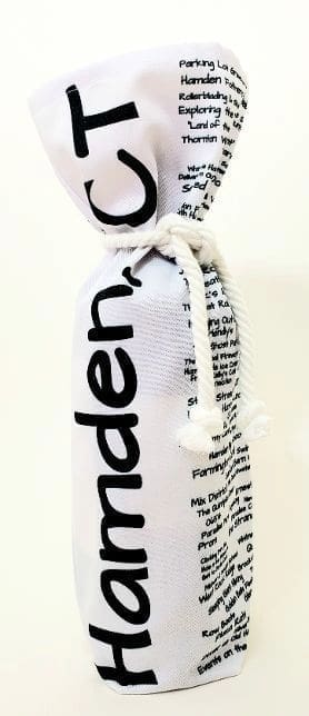 A bottle of wine in a white bag