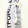 A bottle of wine is wrapped in newspaper.