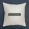 A white pillow with the words ivory maisoncode on it.