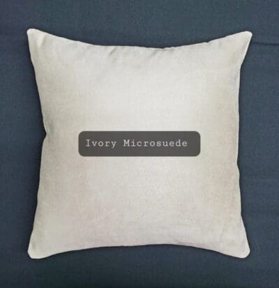 A pillow with the word ivory microsuede on it.