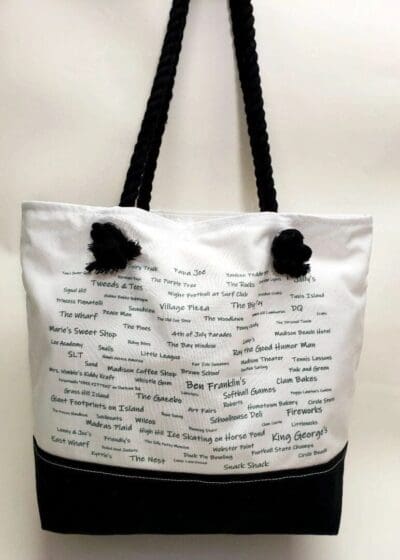 A white and black bag with writing on it