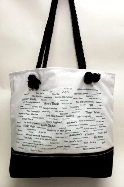 A white and black bag with writing on it