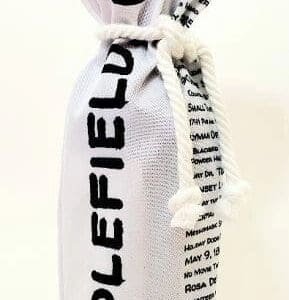 A bottle of wine is wrapped in newspaper.