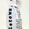 A bottle of wine wrapped in newspaper.