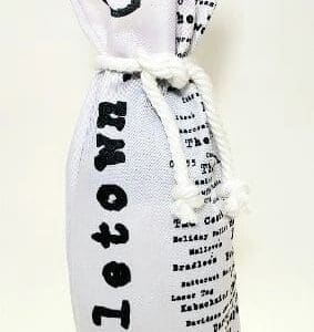 A bottle of wine wrapped in newspaper.