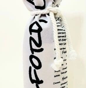 A bottle of wine wrapped in fabric with the word " fozo " written on it.