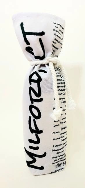 A bottle of wine wrapped in fabric with the word " fozo " written on it.