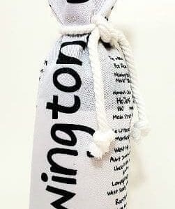 A bottle of wine is wrapped in newspaper.