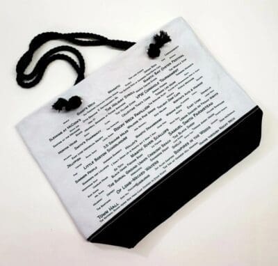 A bag with a black strap and some words on it